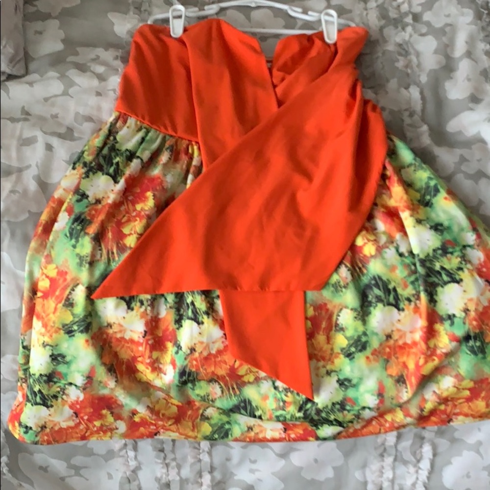 I am selling a short orange strapless dress.